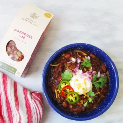 Women's Bean Project firehouse chili laid mix laid out next to a prepared bowl of the chili.