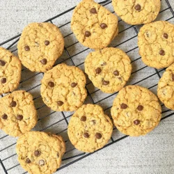 Women's Bean Project freshly prepared chocolate chip oatmeal cookies sitting on a cooling rack