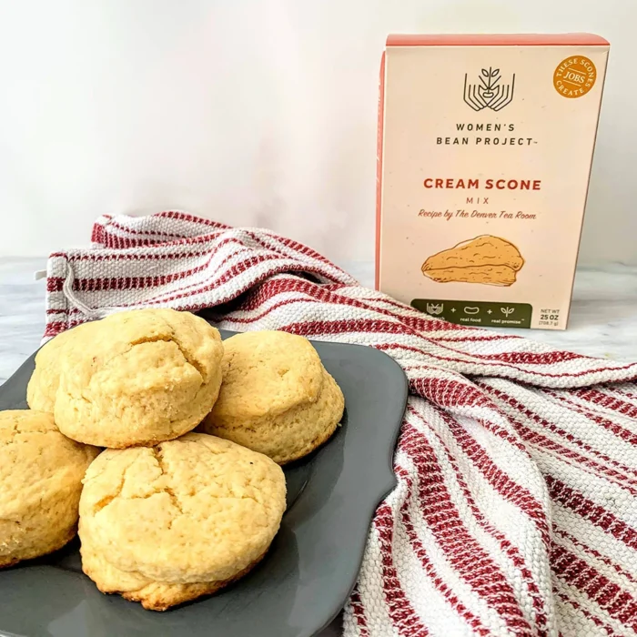 Women's Bean Project cream scone mix stands behind a plate of fresh scones