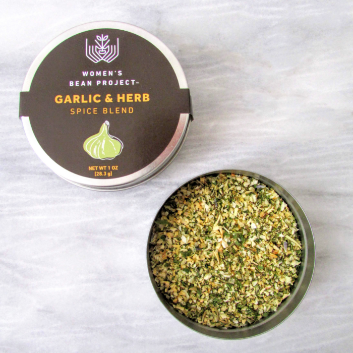 An open tin of Women's Bean Project Garlic and Herb Spice Blend.