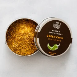 An open tin of Women's Bean Project Green Chili Spice Blend.